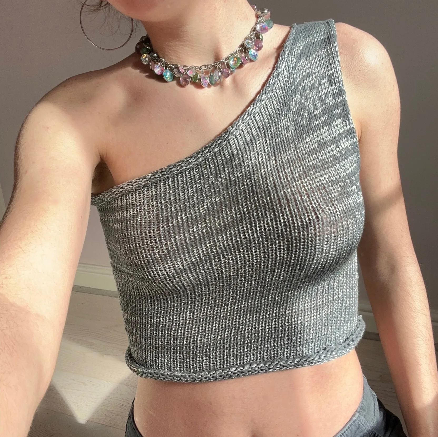 Handmade knitted metallic asymmetrical one shoulder top in silver and grey
